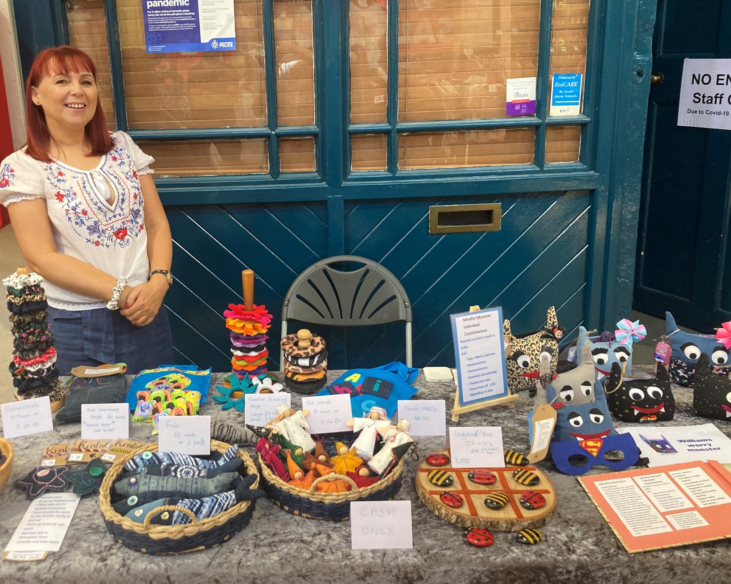 Julie stood by a table of her products.