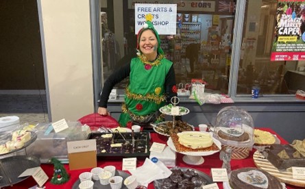 Julie stood by a table of her products.